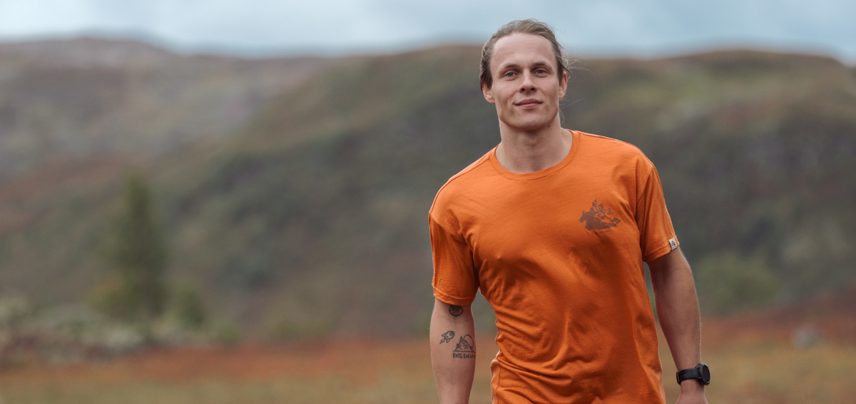 Man hiking in an Aclima LightWool 140 merino t-shirt